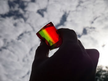 Close-up of hand holding multi colored candies