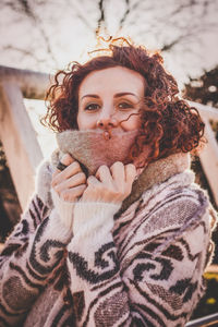 Portrait of woman sitting on footbridge