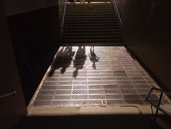 Shadow of people walking on staircase