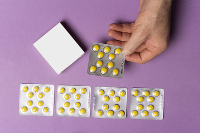 Cropped hand of woman holding pills