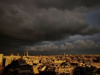 High angle view of cityscape against storm clouds