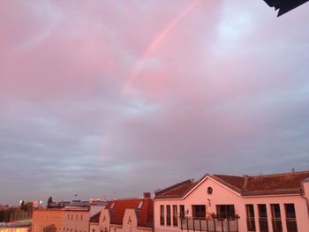 Low angle view of houses against cloudy sky