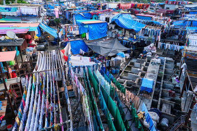 Dhobi ghat is an open air laundromat lavoir in mumbai, india with laundry drying on ropes