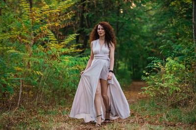 Portrait of woman standing in forest