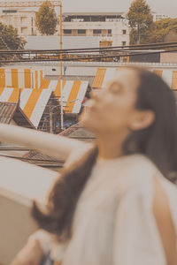 Portrait of woman standing against built structure