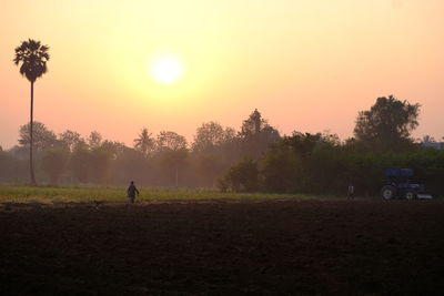 Scenic view of field against sky during sunset