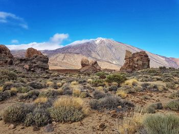 Scenic view of desert against blue sky