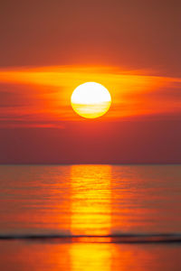 Scenic view of sea against romantic sky at sunset