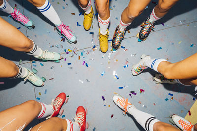 Legs of women wearing roller skates celebrating together