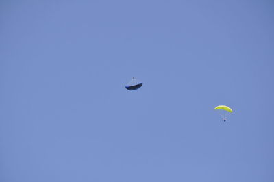 Low angle view of hot air balloon against clear blue sky