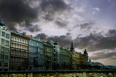 Low angle view of buildings against cloudy sky