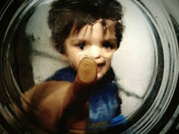 Child behind glass