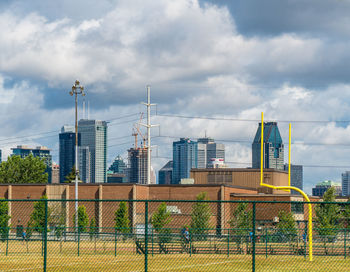 Buildings seen through chainlink fence