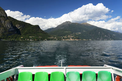 Cropped boat in calm lake against mountain range