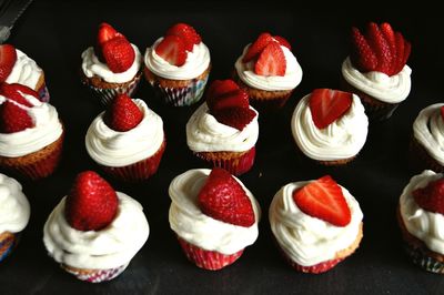 Close-up of cupcakes against black background