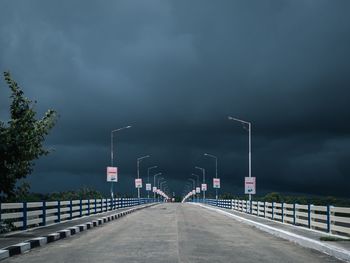 Road by bridge against sky