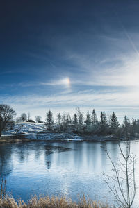 Scenic view of lake against sky during winter