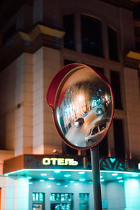 Low angle view of illuminated glass building at night