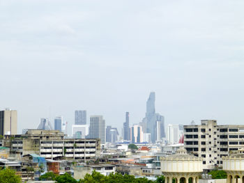 Buildings in city against sky