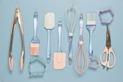 Directly above shot of kitchen utensils against blue background