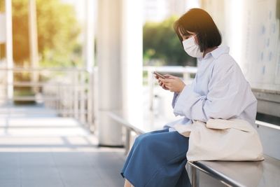 Side view of woman using mobile phone