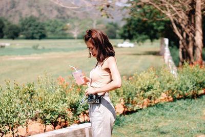 Side view of woman standing on field