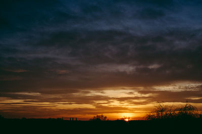 Scenic view of dramatic sky at sunset
