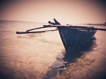 Boats in sea at sunset