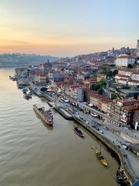 Old town porto view from the bridge. medieval ribeira, boats and douro river. sunset, twilight 