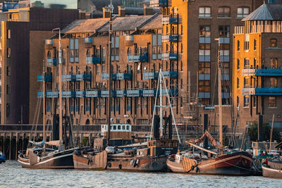 Boats and small ships docked on a river thames in london, uk.