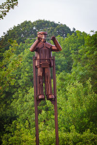 Low angle view of statue against trees