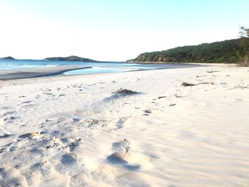 Scenic view of beach against clear sky