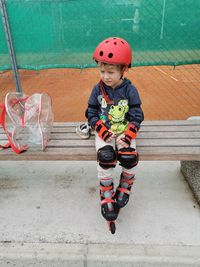 Full length of boy standing on footpath