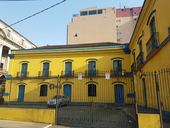 Low angle view of yellow building against sky