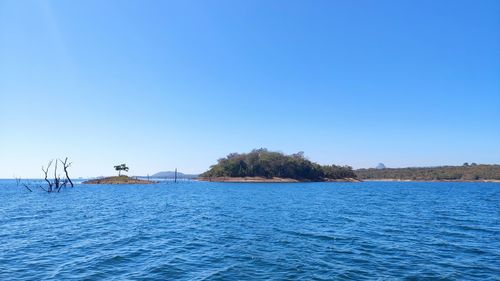 Scenic view of sea against clear blue sky