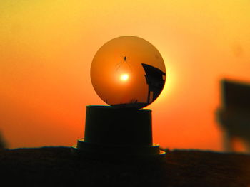 View of illuminated lights at sunset