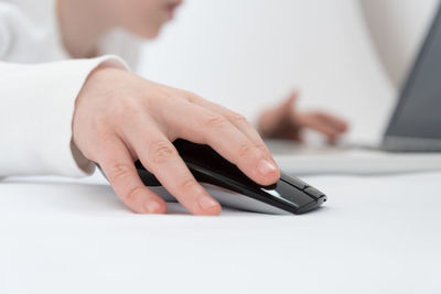 Close-up of person using laptop on table