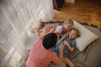 High angle view of mother and daughter at home