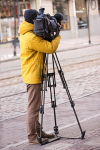 Woman photographing with umbrella