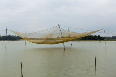 Large square-shaped fishing net over water off cam nam, hoi an, central vietnam