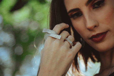 Close-up portrait of woman holding hands