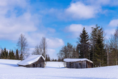 Snow covered field against sky