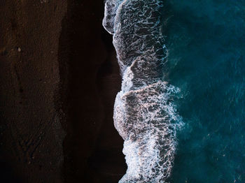 High angle view of waves splashing at shore