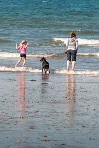 Woman with dog on beach