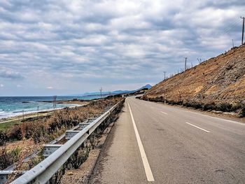 Road by sea against sky