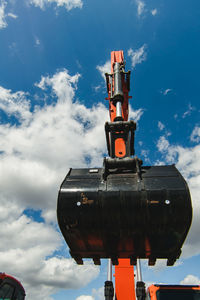 Low angle view of bulldozer against sky