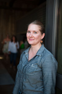 Portrait of woman standing at doorway