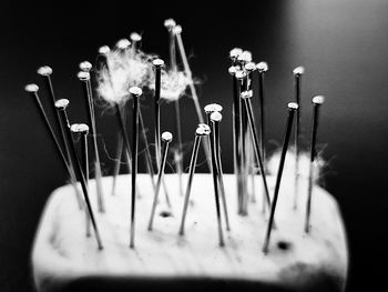Close-up of candles on table against black background