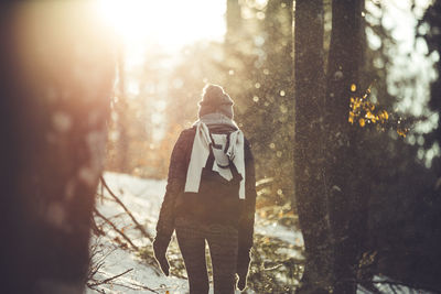 Man holding umbrella standing in snow