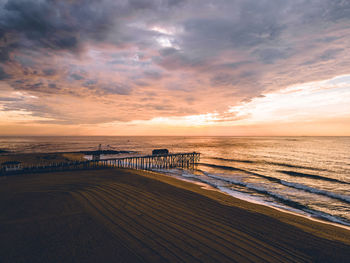 Scenic view of beach against sky during sunset